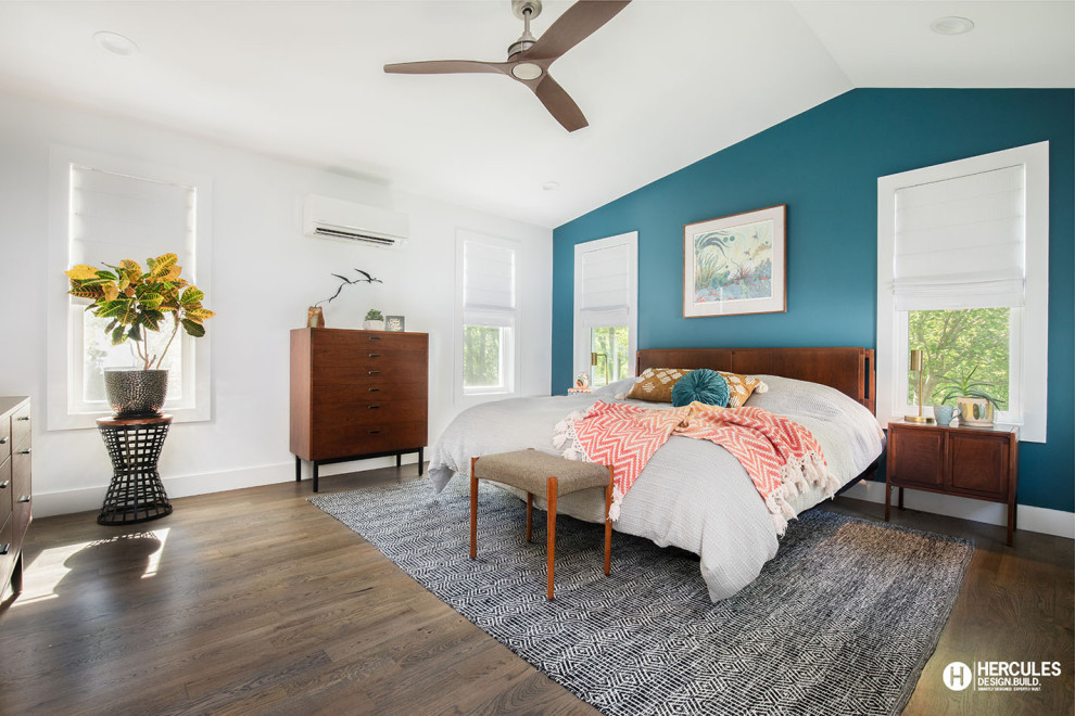 Foto di una camera matrimoniale minimalista di medie dimensioni con pareti blu, pavimento in legno massello medio, pavimento grigio e soffitto a volta