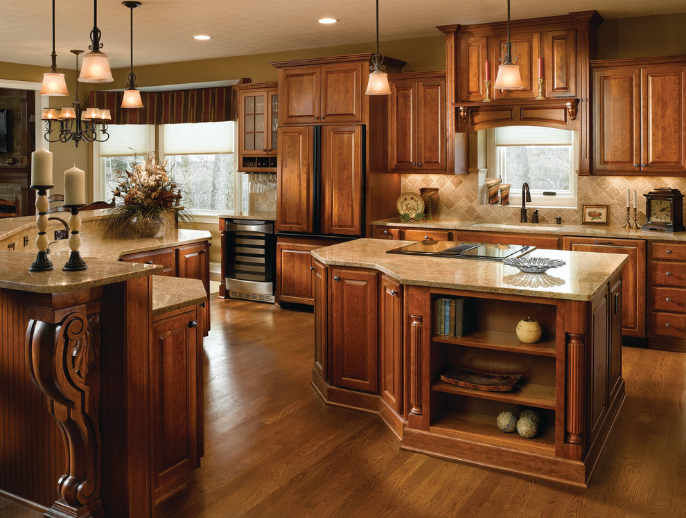 Inspiration for a large traditional u-shaped separate kitchen in Other with a double-bowl sink, raised-panel cabinets, dark wood cabinets, granite benchtops, beige splashback, travertine splashback, stainless steel appliances, medium hardwood floors, with island, brown floor and beige benchtop.