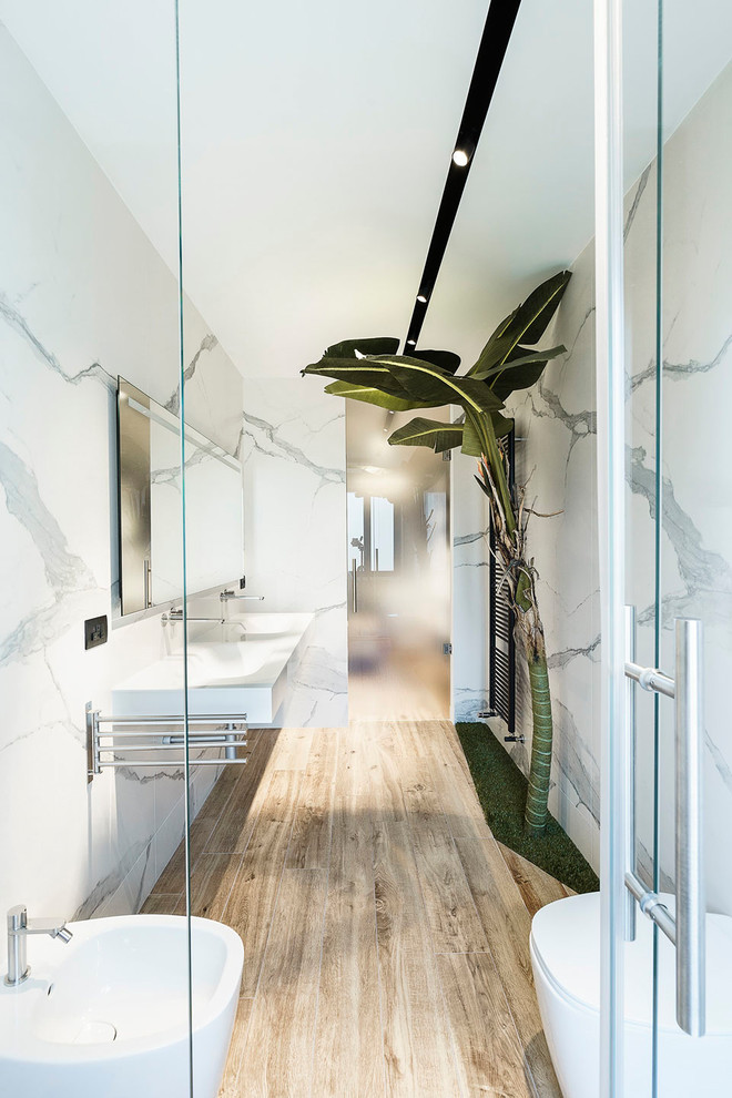 Large contemporary master bathroom in Rome with an alcove shower, a bidet, white tile, marble, white walls, porcelain floors, a wall-mount sink, brown floor and a hinged shower door.