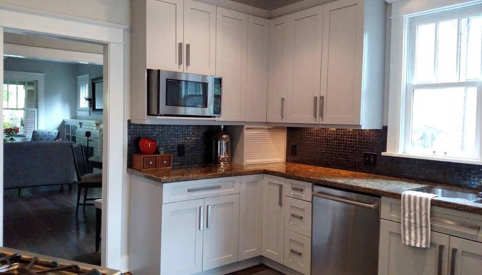 Example of a small transitional dark wood floor eat-in kitchen design in Denver with a double-bowl sink, shaker cabinets, gray cabinets, granite countertops, metallic backsplash, stainless steel appliances, glass tile backsplash and a peninsula
