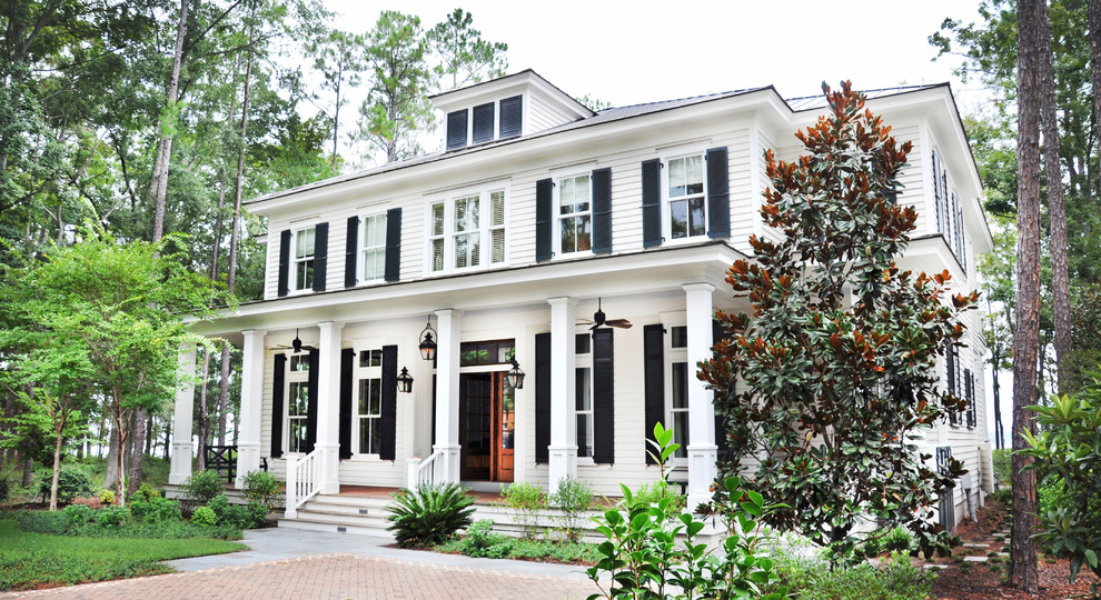 Traditional two-storey white exterior in Atlanta with wood siding and a hip roof.