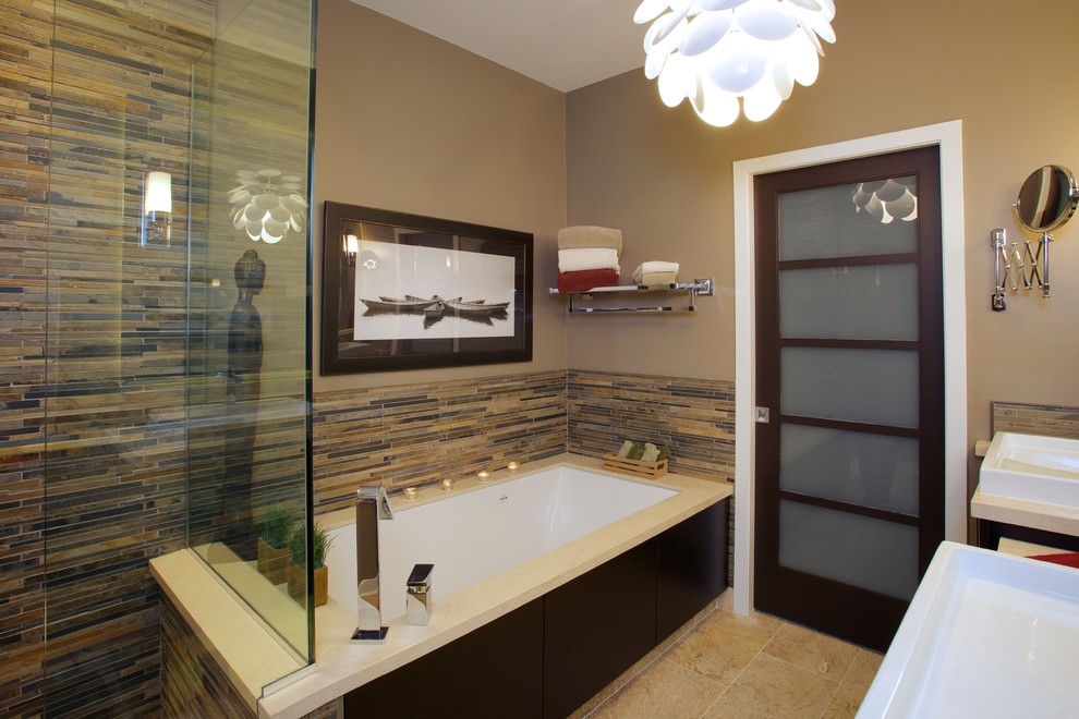 Photo of a large asian master bathroom in Chicago with flat-panel cabinets, dark wood cabinets, multi-coloured tile, an undermount tub, a corner shower, a one-piece toilet, matchstick tile, beige walls, travertine floors, a vessel sink and solid surface benchtops.