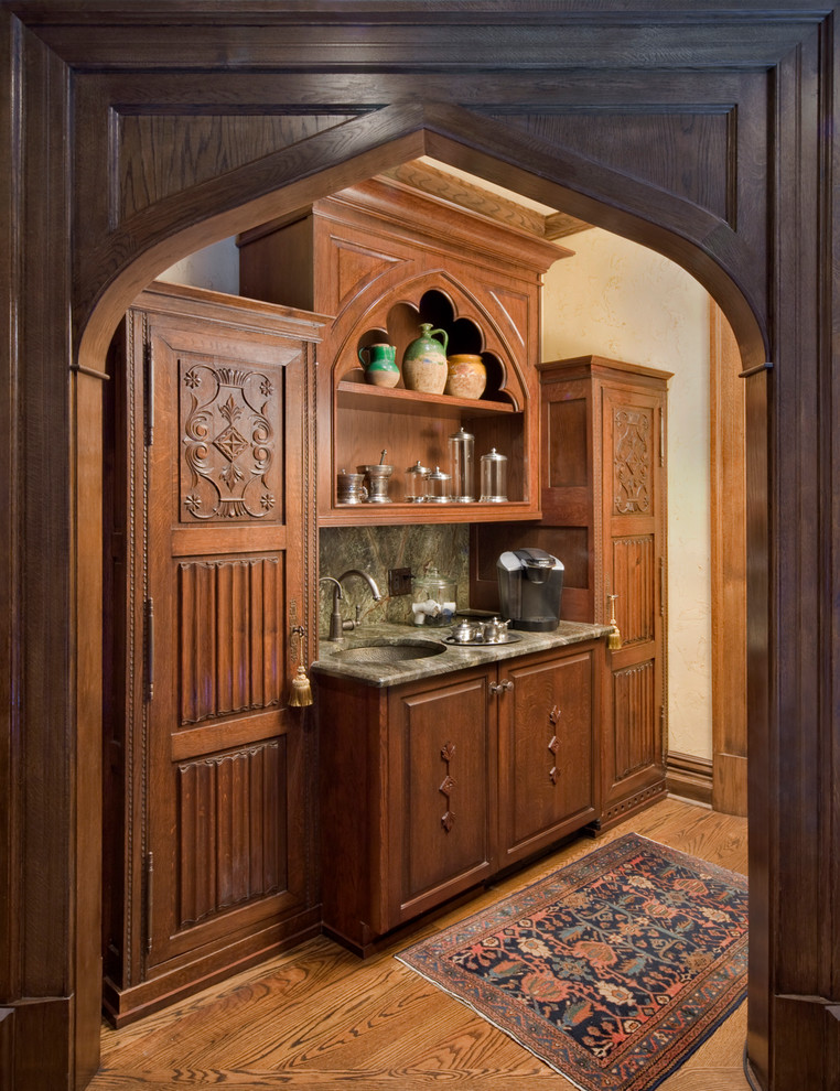 This is an example of a mid-sized traditional single-wall wet bar in Charlotte with raised-panel cabinets.