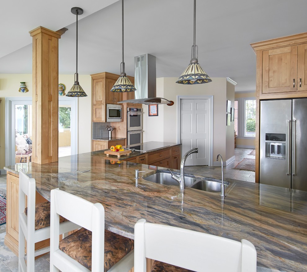 Example of a large transitional l-shaped porcelain tile and multicolored floor open concept kitchen design in Baltimore with an undermount sink, recessed-panel cabinets, light wood cabinets, quartzite countertops, green backsplash, glass tile backsplash, stainless steel appliances and a peninsula