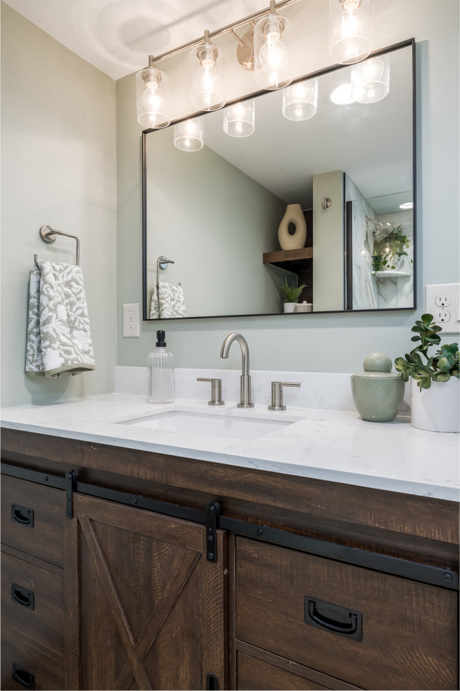 This is an example of a mid-sized transitional 3/4 bathroom in Minneapolis with brown cabinets, an alcove shower, a one-piece toilet, multi-coloured tile, porcelain tile, green walls, laminate floors, an undermount sink, engineered quartz benchtops, brown floor, a hinged shower door, white benchtops, a single vanity, a freestanding vanity and flat-panel cabinets.