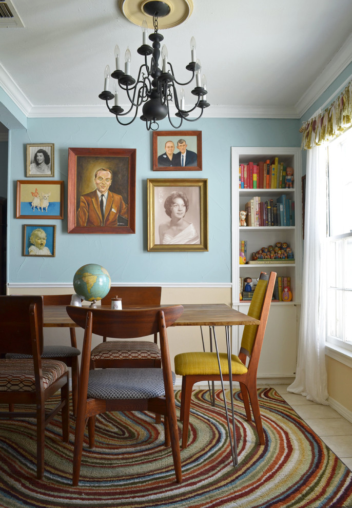 This is an example of an eclectic dining room in Dallas with blue walls.