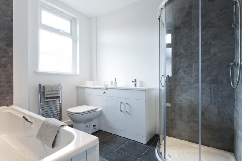This is an example of a modern bathroom in Glasgow with white walls.