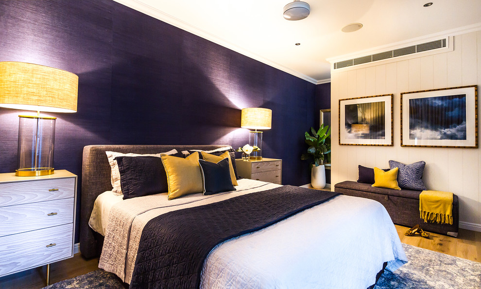 Large transitional master bedroom in Brisbane with blue walls, medium hardwood floors and brown floor.