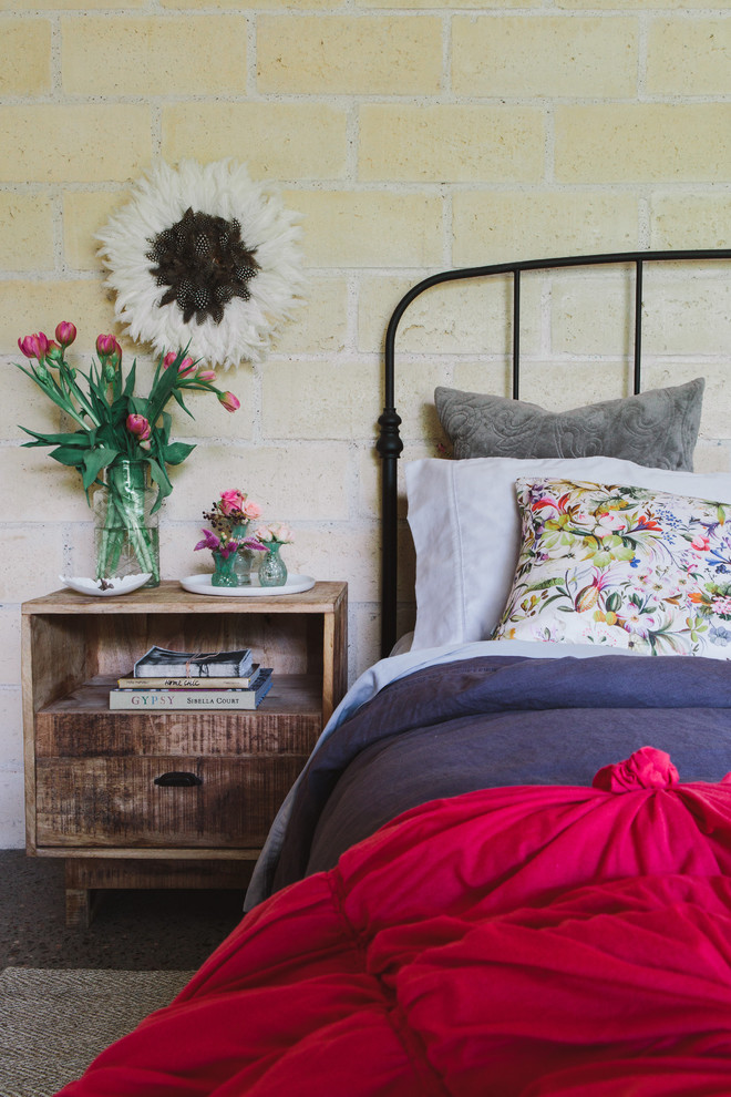 Inspiration for a large country guest bedroom in Sydney with concrete floors.