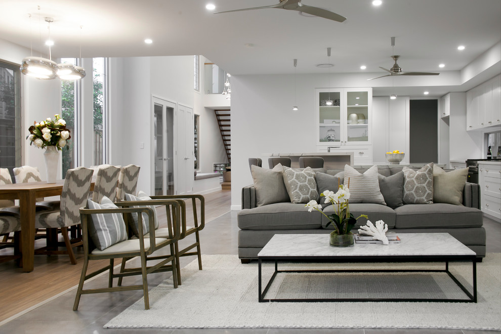 This is an example of a large contemporary formal open concept living room in Brisbane with white walls, ceramic floors, no fireplace, a wall-mounted tv and grey floor.