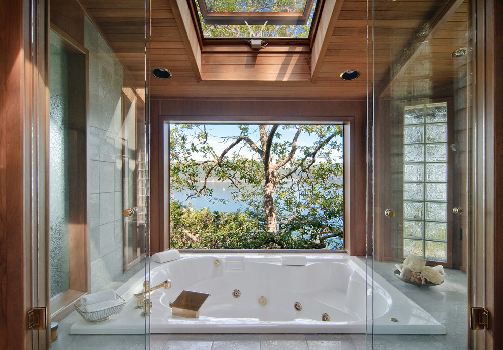 Inspiration for a country master bathroom in Seattle with an undermount sink, flat-panel cabinets, medium wood cabinets, granite benchtops, a hot tub, beige tile, stone tile, green walls and ceramic floors.