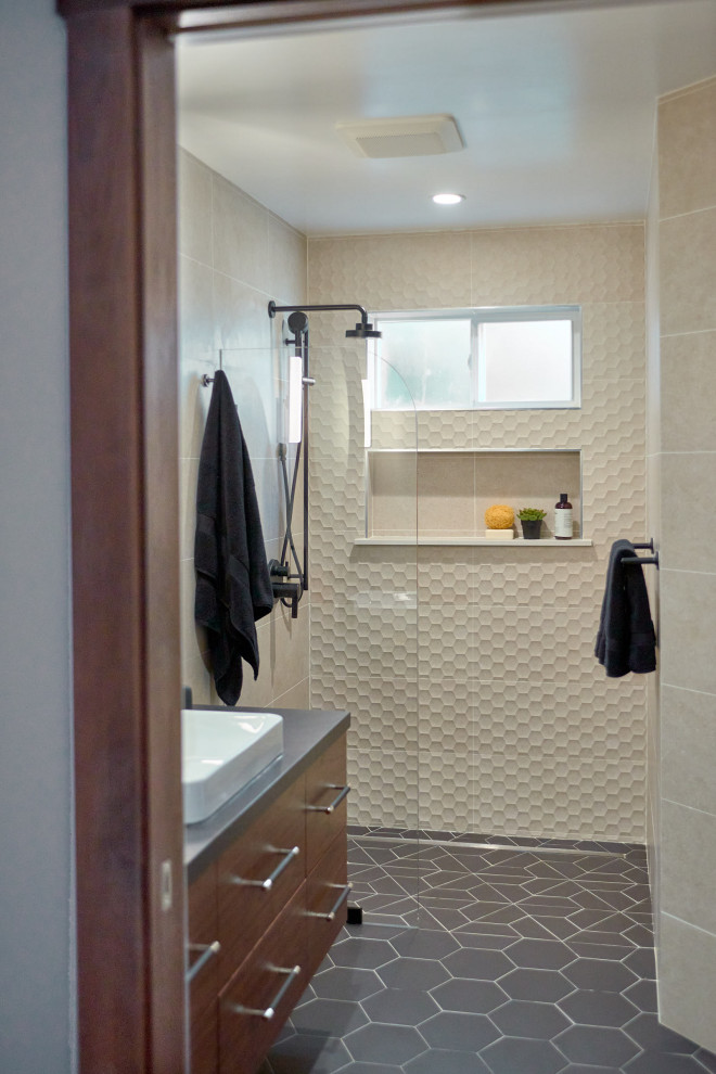 This is an example of a mid-sized modern 3/4 bathroom in San Francisco with flat-panel cabinets, dark wood cabinets, a curbless shower, a one-piece toilet, porcelain tile, beige walls, porcelain floors, a vessel sink, solid surface benchtops, black floor, an open shower, a niche, a single vanity and a floating vanity.