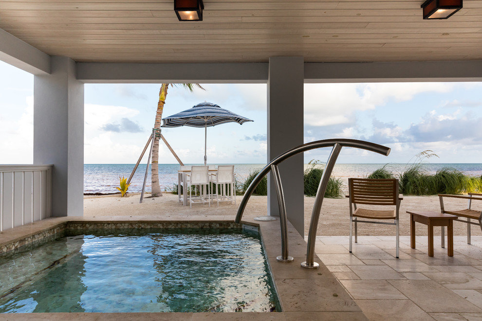 Example of a beach style home design design in Miami