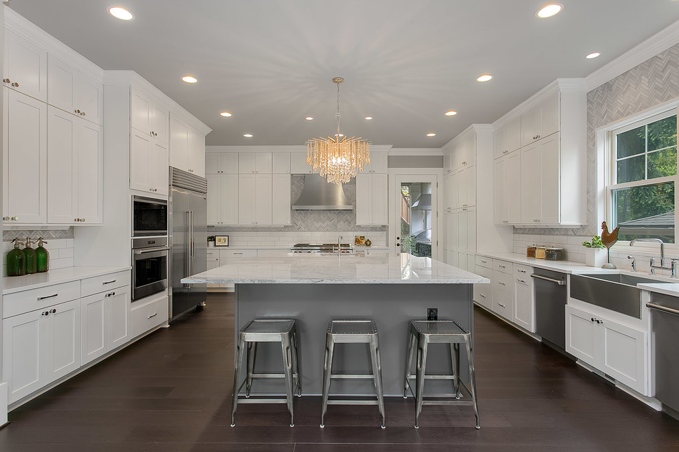 Design ideas for an expansive transitional u-shaped eat-in kitchen in Seattle with a farmhouse sink, flat-panel cabinets, white cabinets, marble benchtops, multi-coloured splashback, stainless steel appliances, dark hardwood floors and with island.