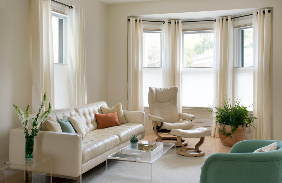 Photo of a mid-sized transitional enclosed family room in Boston with beige walls, light hardwood floors, no fireplace, a wall-mounted tv and beige floor.