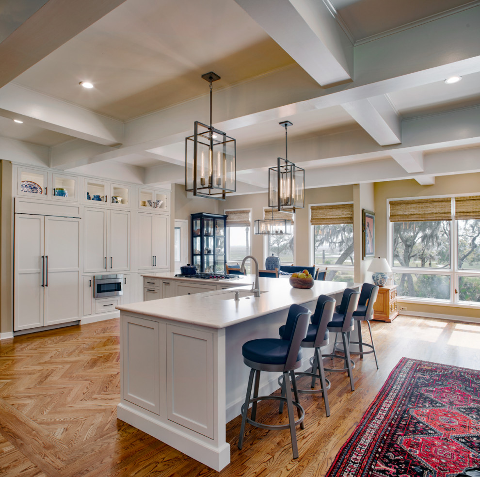 Example of a large transitional medium tone wood floor and coffered ceiling open concept kitchen design in Atlanta with a single-bowl sink, shaker cabinets, white cabinets, quartz countertops, stainless steel appliances, an island and white countertops