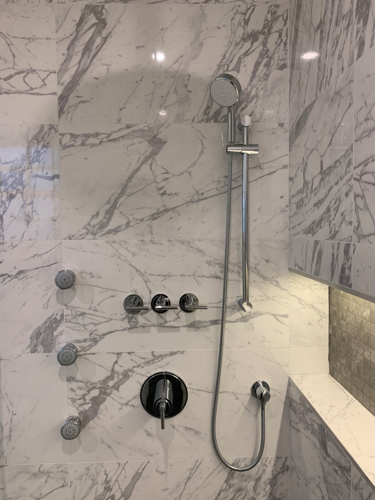 This is an example of a large traditional ensuite bathroom in Vancouver with shaker cabinets, white cabinets, a freestanding bath, an alcove shower, a bidet, grey tiles, porcelain tiles, white walls, porcelain flooring, a submerged sink, engineered stone worktops, grey floors, a hinged door, multi-coloured worktops, a wall niche, double sinks and a built in vanity unit.