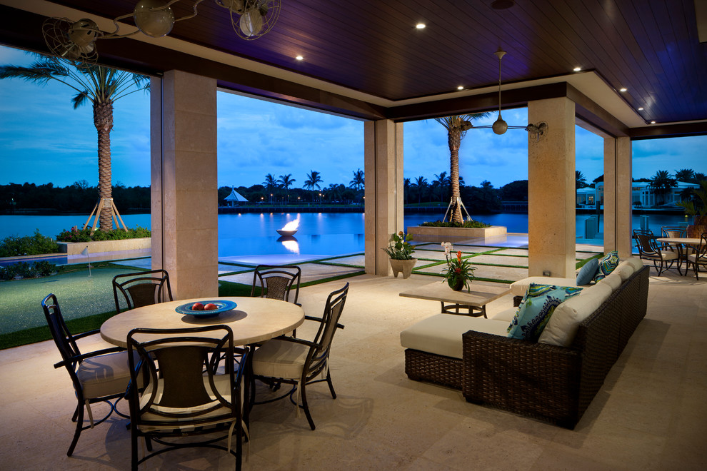 Design ideas for a tropical patio in Miami with a fire feature.