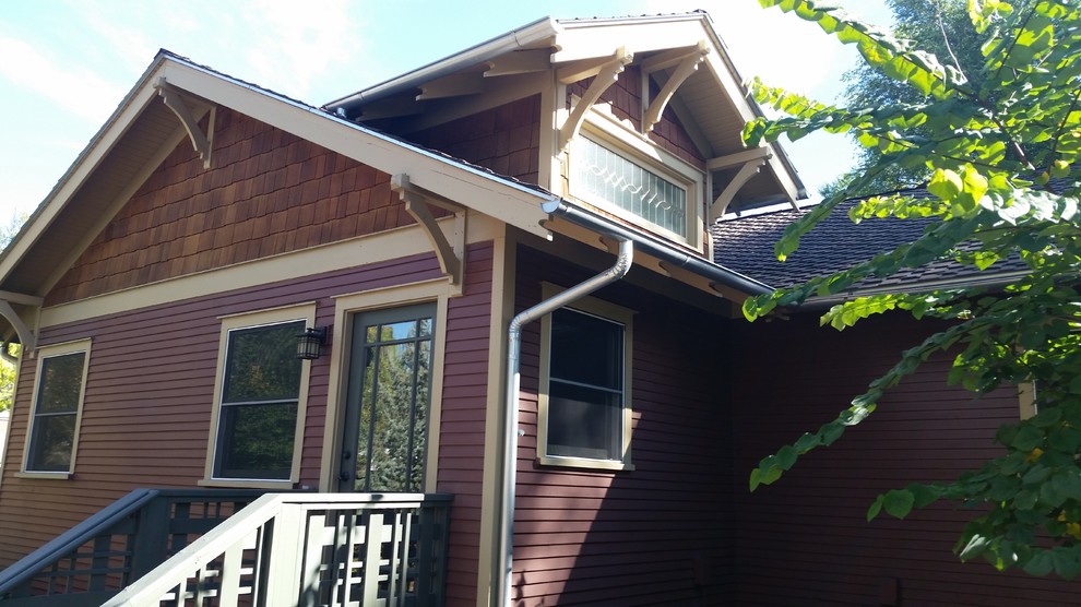 Mid-sized arts and crafts one-storey red house exterior in Denver with wood siding, a gable roof and a shingle roof.