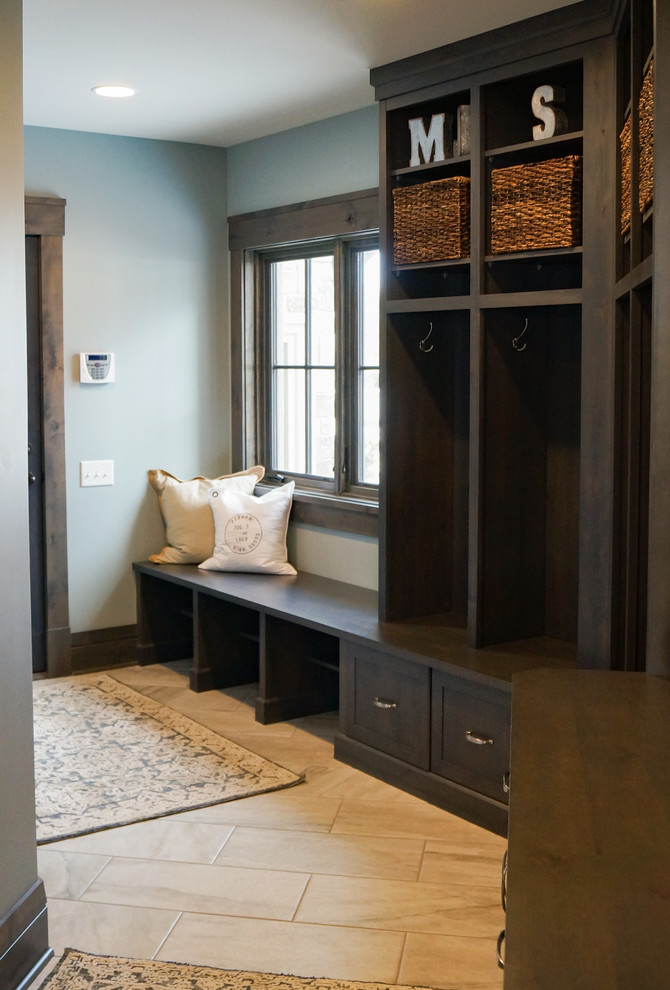 Design ideas for a large transitional mudroom in Other with blue walls, ceramic floors, a single front door, a dark wood front door and grey floor.