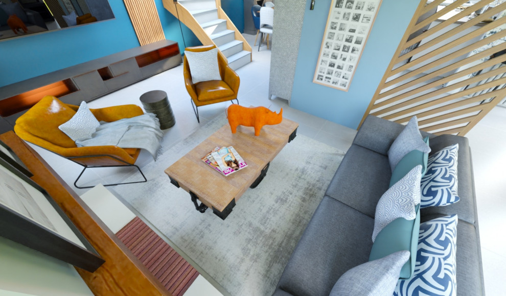 Esempio di un grande soggiorno minimalista aperto con libreria, pareti blu, pavimento con piastrelle in ceramica, camino classico, cornice del camino in cemento, pavimento grigio e carta da parati