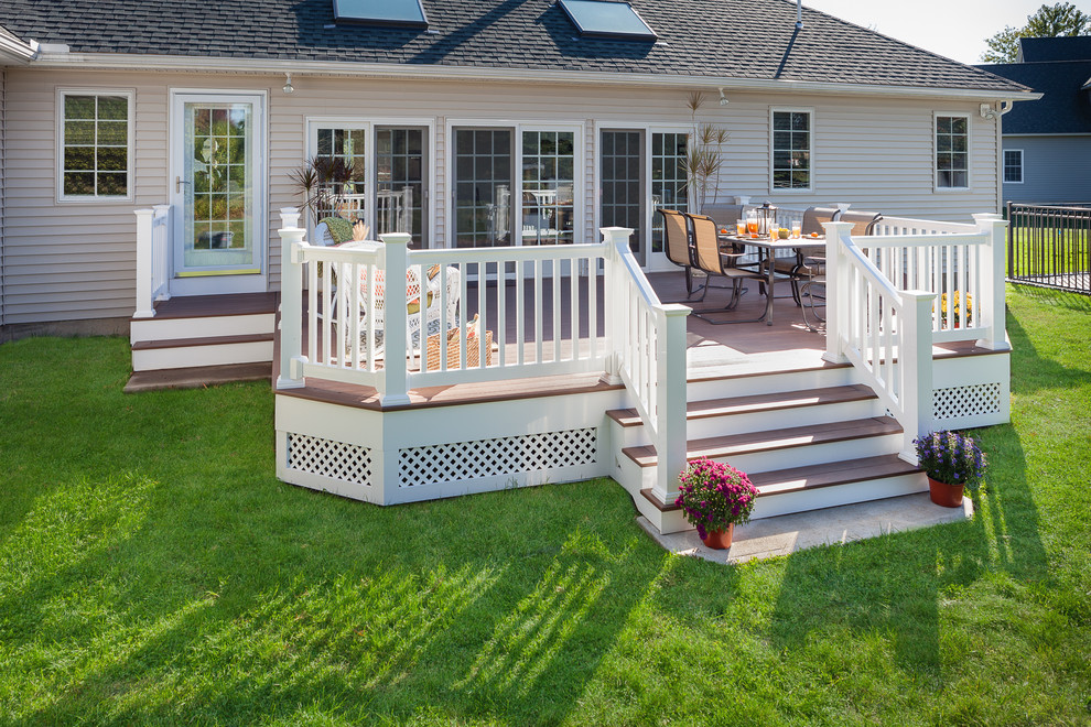 This is an example of a mid-sized arts and crafts backyard deck in Boston with an outdoor kitchen and no cover.