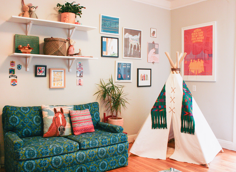 Nursery - eclectic girl medium tone wood floor nursery idea in San Francisco with beige walls