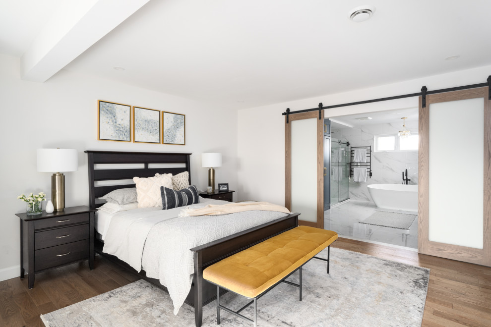 Design ideas for an expansive contemporary master bedroom in Montreal with grey walls, light hardwood floors, a standard fireplace, brown floor and vaulted.