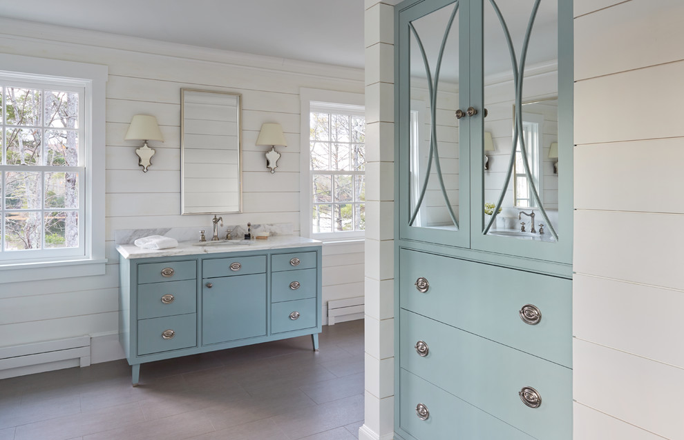 Photo of a transitional bathroom in Portland Maine with furniture-like cabinets, blue cabinets, marble benchtops and white benchtops.