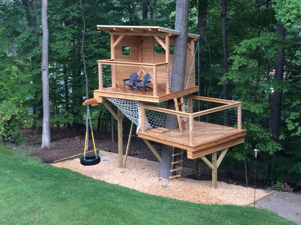 This is an example of a mid-sized modern light wood floor gender-neutral outdoor playset in Boston with brown walls.
