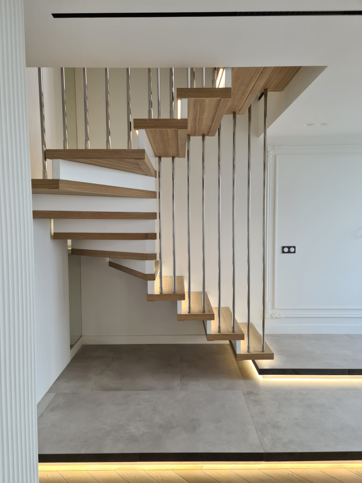Inspiration for a large contemporary wood u-shaped staircase in Moscow with wood risers, metal railing and brick walls.