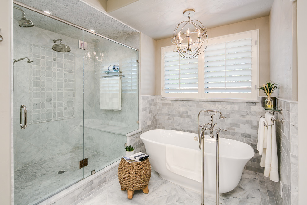 Freestanding bathtub - small transitional master white tile, gray tile and marble tile marble floor and white floor freestanding bathtub idea in Denver with a hinged shower door, recessed-panel cabinets, gray cabinets, an undermount sink, marble countertops and beige walls