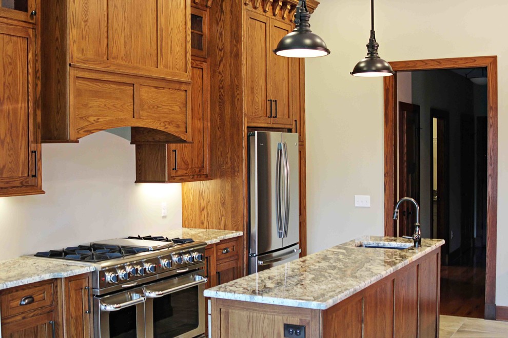 Inspiration for a rustic kitchen remodel with dark wood cabinets, granite countertops and an island