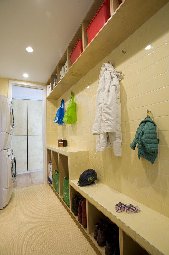 Contemporary laundry room in Charlotte with a stacked washer and dryer.