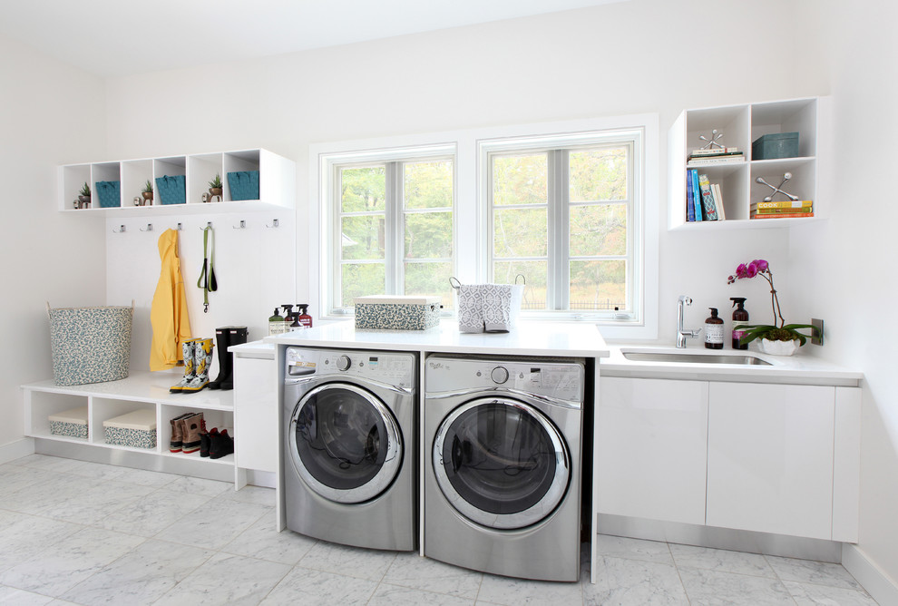 Design ideas for a large transitional single-wall utility room in Other with an undermount sink, flat-panel cabinets, white cabinets, white walls, a side-by-side washer and dryer, quartz benchtops, marble floors and white floor.