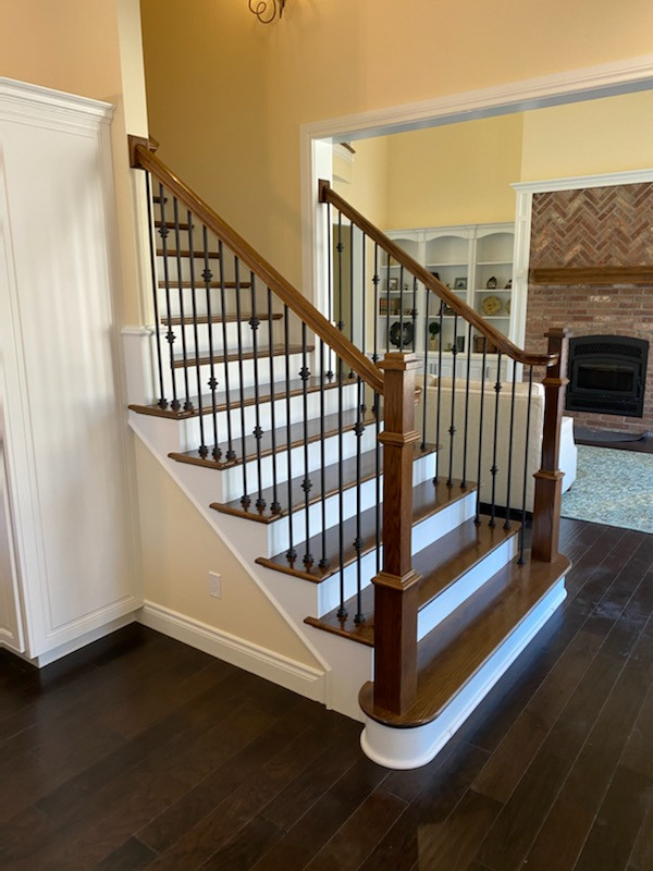 Paint and stain staircase with living room view