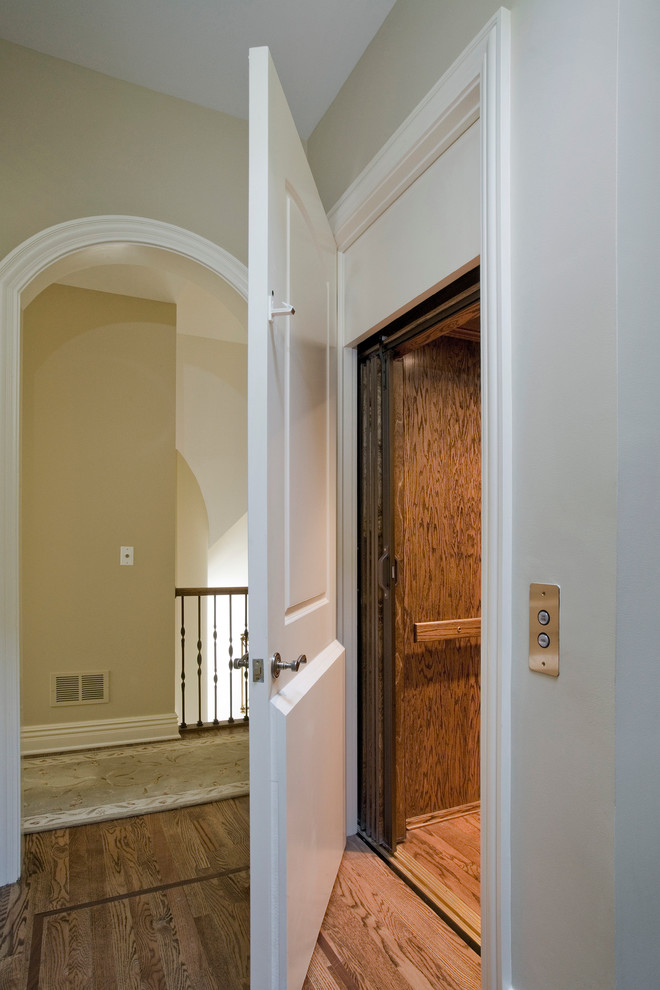 Design ideas for a mid-sized traditional hallway in Chicago with beige walls and medium hardwood floors.