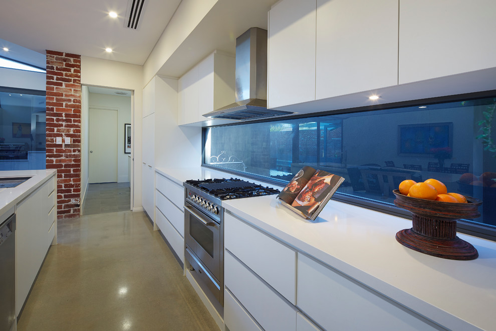 Contemporary kitchen in Perth with stainless steel appliances, concrete floors and with island.