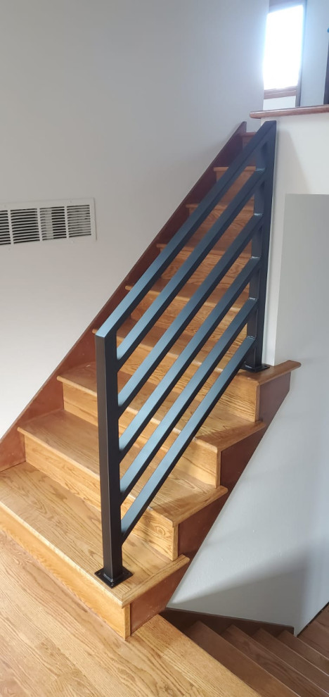 Inspiration for a mid-sized midcentury wood straight staircase in Portland with wood risers and metal railing.