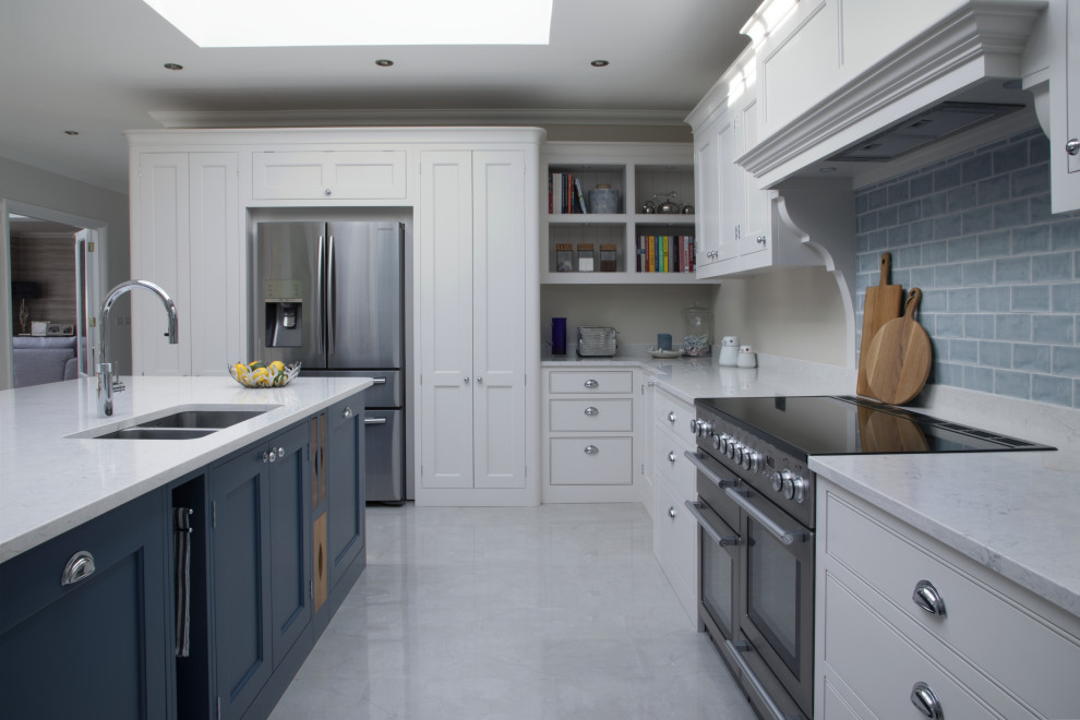 Example of a mid-sized transitional l-shaped ceramic tile and gray floor eat-in kitchen design in Surrey with an undermount sink, shaker cabinets, gray cabinets, quartzite countertops, blue backsplash, subway tile backsplash, stainless steel appliances, an island and white countertops
