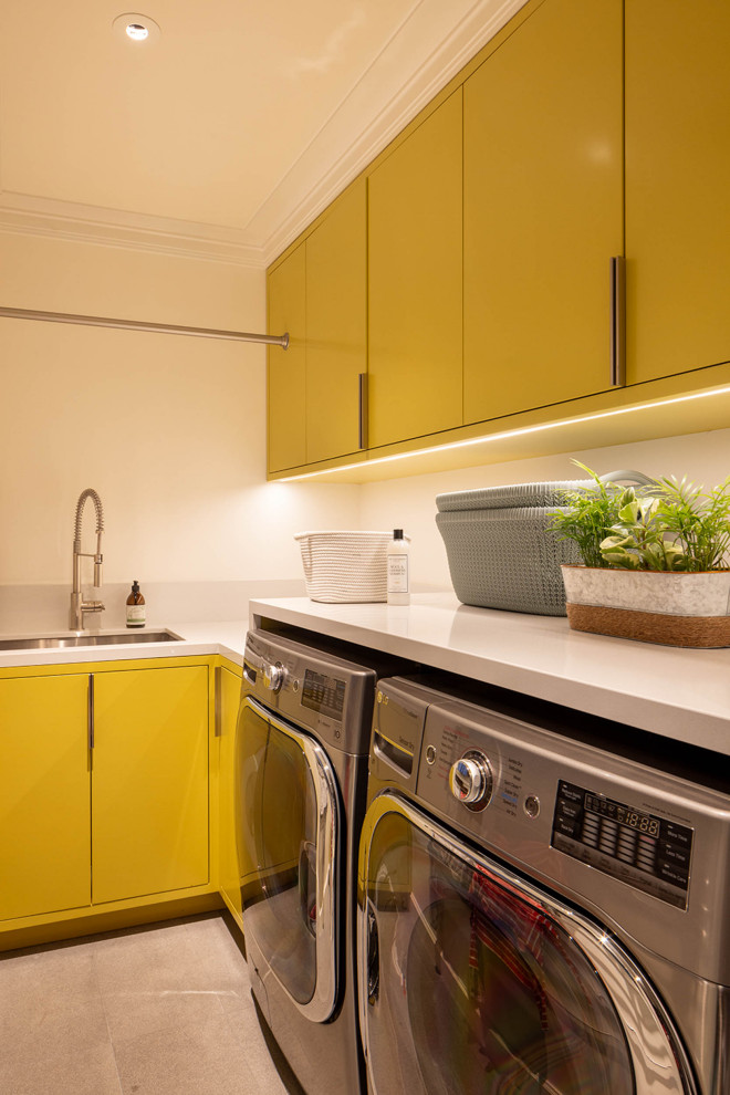 Expansive transitional dedicated laundry room in San Francisco with flat-panel cabinets and yellow cabinets.