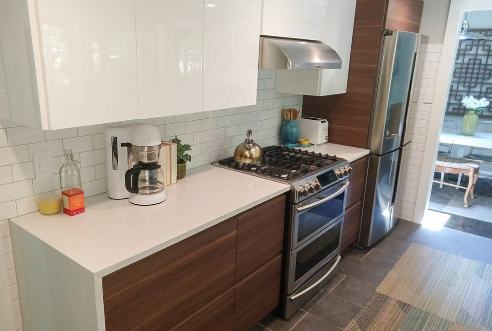 Small midcentury galley eat-in kitchen in Other with an undermount sink, flat-panel cabinets, brown cabinets, quartzite benchtops, white splashback, subway tile splashback, stainless steel appliances, cement tiles, no island, grey floor and white benchtop.