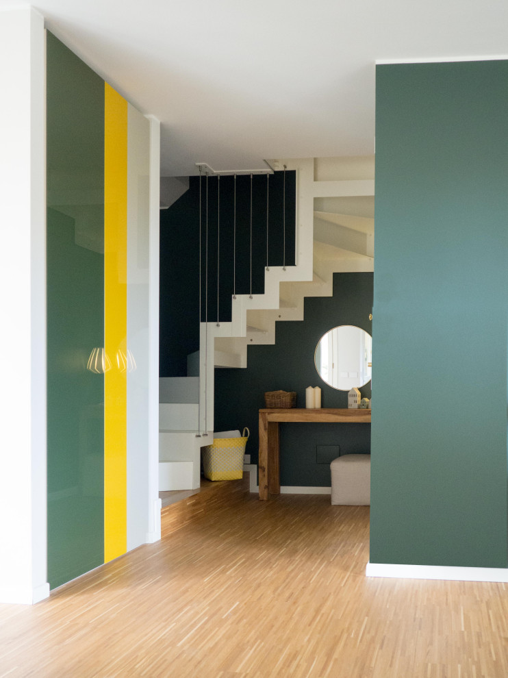 Inspiration for an expansive contemporary painted wood u-shaped staircase in Other with painted wood risers and cable railing.