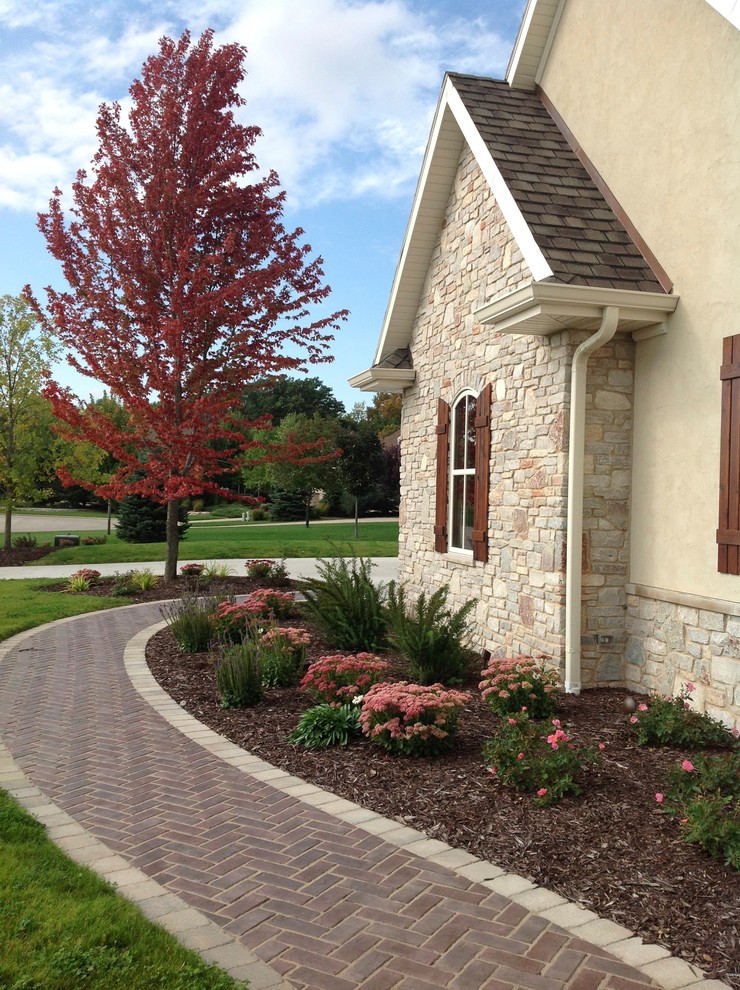 Inspiration for a large rustic front yard patio remodel with no cover