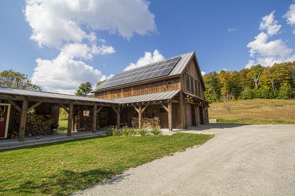 Mid-sized mountain style brown two-story wood gable roof photo with a metal roof