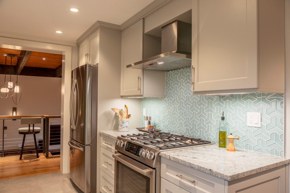 Inspiration for a transitional eat-in kitchen remodel in Boston with blue backsplash