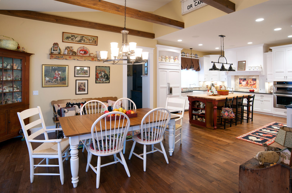 Inspiration for a country u-shaped eat-in kitchen with a farmhouse sink, shaker cabinets, white cabinets, beige splashback, panelled appliances, wood benchtops, medium hardwood floors, with island and exposed beam.