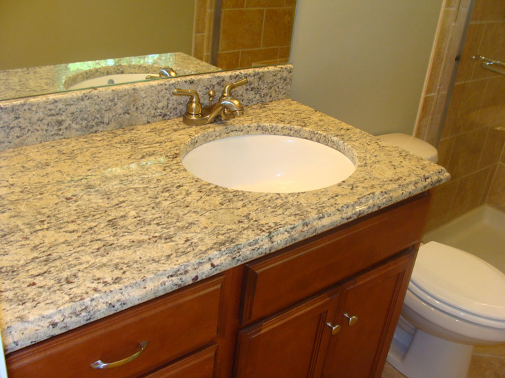 Beige tile bathroom photo with an undermount sink