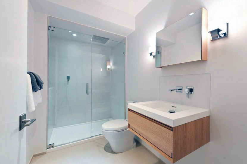 This is an example of a mid-sized modern 3/4 bathroom in Chicago with flat-panel cabinets, light wood cabinets, an alcove shower, white tile, white walls, ceramic floors, an integrated sink and solid surface benchtops.