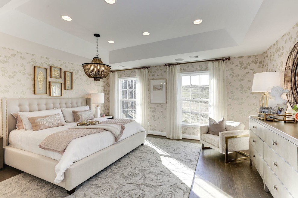 Photo of a transitional master bedroom in DC Metro with beige walls, medium hardwood floors and brown floor.